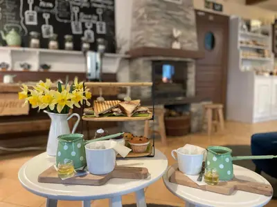 a table with a tray of food and flowers on it at Guest House Pod Grebenom in Podčetrtek