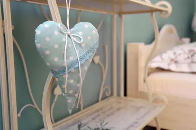 a mirror with a heart with a bow at Apartments Life & Energy in Čatež ob Savi