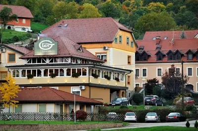 a building with acedes sign on top of it at Apartments Life & Energy in Čatež ob Savi