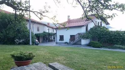 a white house with a yard in front of it at Janezinovi House in Ratečevo Brdo