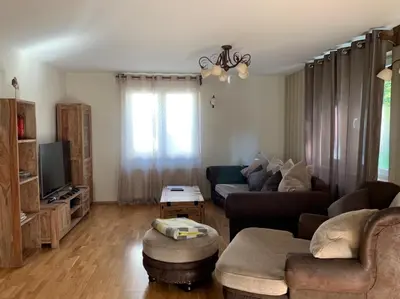 a living room with a couch and a tv at Remarkable home Bohinj Lake in Bohinj