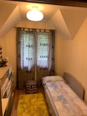 a bedroom with two beds and a window with curtains at Remarkable home Bohinj Lake in Bohinj