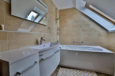 a bathroom with a sink and a tub and a mirror at Remarkable home Bohinj Lake in Bohinj