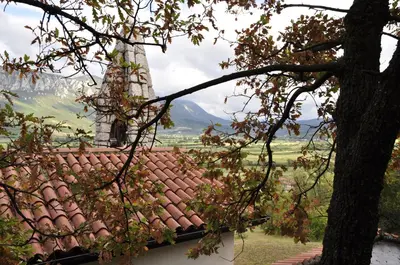 a roof of a house with a tower and a tree at Holiday Home Slavi in Vipava