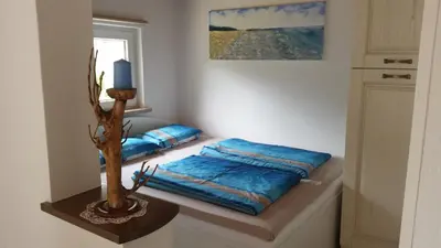 a room with two beds and a candle on a table at Holiday Home Slavi in Vipava