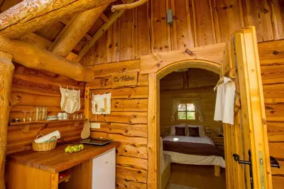 a bedroom in a log cabin with a bed at Glamping Organic Farm Slibar in Tržič