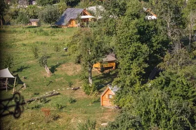 an aerial view of a small house on a hill at Glamping Organic Farm Slibar in Tržič