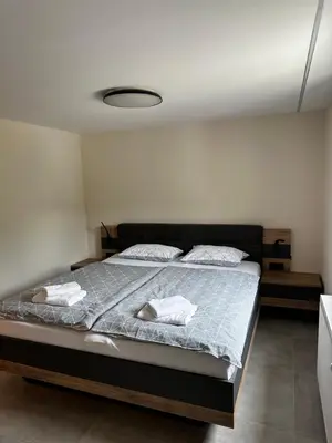 a bedroom with a bed with two towels on it at Martinova izba - Rooms & Apartments in Laško