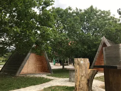 a monument in a park next to some trees at Martinova izba - Rooms & Apartments in Laško