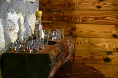 a group of wine glasses sitting on a wooden table at Martinova izba - Rooms & Apartments in Laško