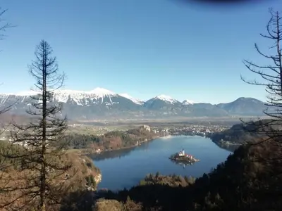 a view of a lake with mountains in the background at Apartma Slivnik in Spodnje Gorje