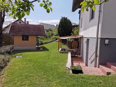 a backyard with a deck and a house at Apartma Slivnik in Spodnje Gorje