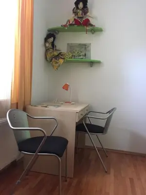 a desk and two chairs in a room at Apartment on Zdraviliski trg 7 in Rogaška Slatina