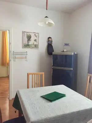 a kitchen with a table and a blue refrigerator at Apartment on Zdraviliski trg 7 in Rogaška Slatina
