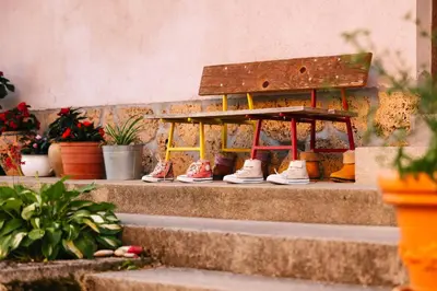 a group of shoes sitting on the steps at Eko Homestead Luka - Escape Room, Archery, BBQ, Rafting and more - in Vrh pri Fari