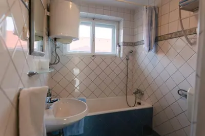 a bathroom with a sink and a bath tub at Eko Homestead Luka - Escape Room, Archery, BBQ, Rafting and more - in Vrh pri Fari