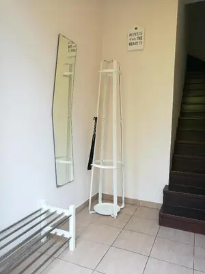 a room with a ladder and a mirror and stairs at Apartment Belaj in Celje