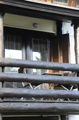 a wooden fence in front of a window at Zeleni Apartment Rogla in Zreče