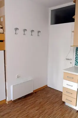 a room with a white wall with the word repair on it at Zeleni Apartment Rogla in Zreče