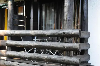 a window of a building with a wooden fence at Zeleni Apartment Rogla in Zreče