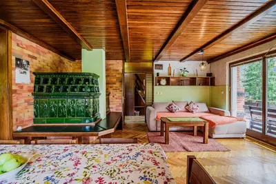 a living room with a couch and a table at Holiday Home Vila Kopriva in Gozd Martuljek