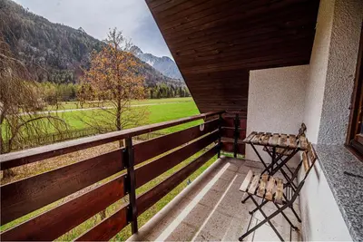 a balcony with a bench and a view of a field at Holiday Home Vila Kopriva in Gozd Martuljek