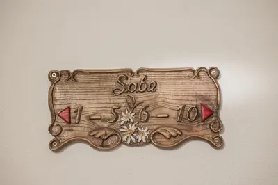 a wooden sign on a wall with the word salsa at EkoTurizem Viženčar in Cerklje na Gorenjskem