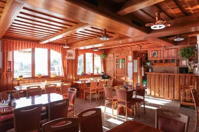 a dining room with wooden tables and chairs at EkoTurizem Viženčar in Cerklje na Gorenjskem