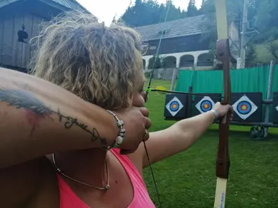 a woman with a tattoo on her arm holding a bow and arrow at Tourist farm Gradišnik in Solčava