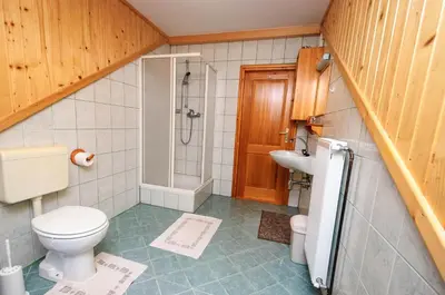 a bathroom with a toilet and a sink at Turistična kmetija Stoglej in Luče