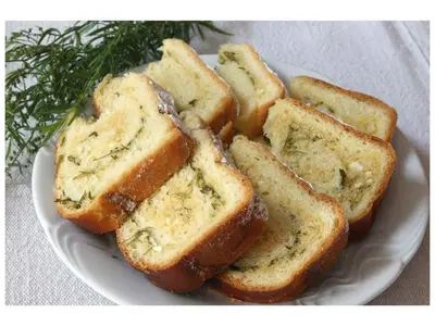 a white plate with slices of bread with butter at Turistična kmetija Stoglej in Luče