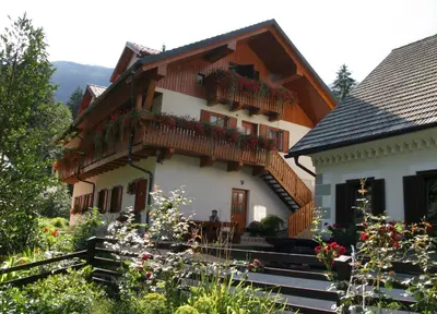 a house with a balcony on the side of it at Turistična kmetija Stoglej in Luče