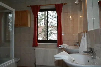a bathroom with two sinks and a window at Apartments Lovšin in Mozirje
