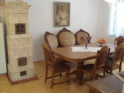 a dining room with a wooden table and chairs at Apartments Lovšin in Mozirje