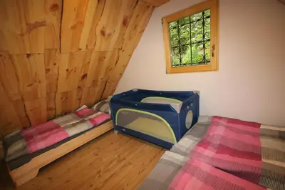 a room with two bunk beds and a window at Fikfak cottage in Bled