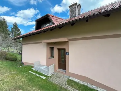 a small house with a door and a lawn at Apartment Panorama in Zreče