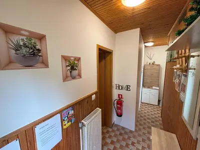a hallway with a fire extinguisher on the wall at Apartment Panorama in Zreče