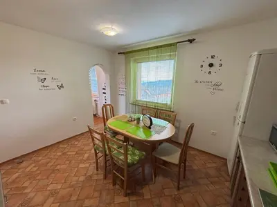 a kitchen with a table and chairs in a room at Apartment Panorama in Zreče