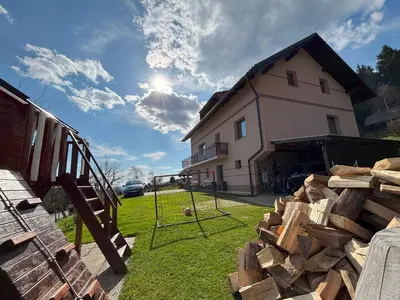 a pile of wood in front of a house at Apartment Panorama in Zreče