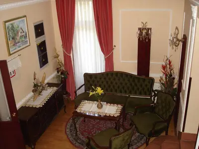 a living room with a couch and chairs and a table at Penzion Gostilna Keber in Domžale
