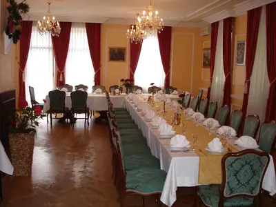 a long dining room with a long table and chairs at Penzion Gostilna Keber in Domžale