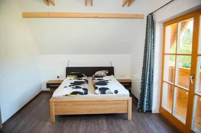 a bedroom with a bed with cows on it at Brunarica Murka in Bohinj