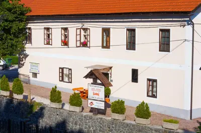 a white building with a sign in front of it at Apartma na Starem Placu in Idrija