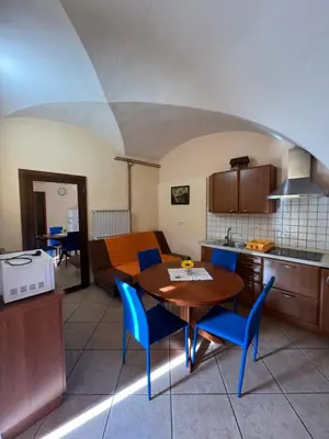 a kitchen and dining room with a table and chairs at Apartma na Starem Placu in Idrija