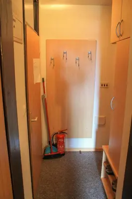 a bathroom with a refrigerator with faucets on the wall at Apartments Rogla in Zreče