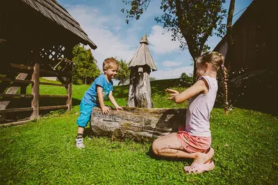 a little boy and a little girl playing with water at Tourist farm Samec in Sele