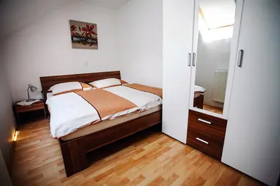 a bedroom with a bed and a large mirror at Tourist farm Samec in Sele