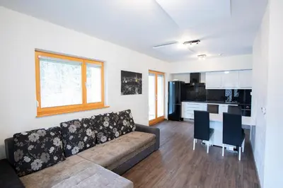 a living room with a couch and a kitchen at Apartments Plan Kranjska Gora in Kranjska Gora