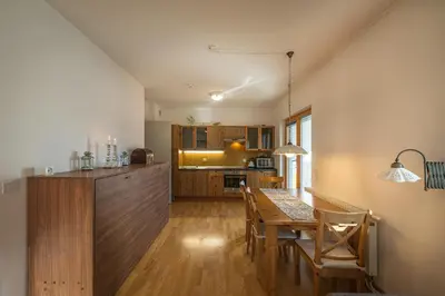 a kitchen and dining room with a wooden table and chairs at Apartments Plan Kranjska Gora in Kranjska Gora