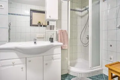 a white bathroom with a sink and a shower at Resort pod orehi - Bled - Apartma & Glamping & Savna in Bled
